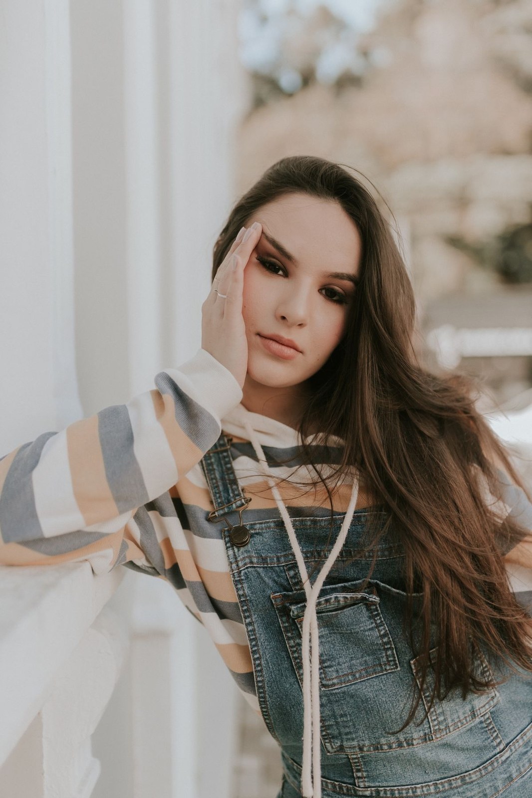 How to style plus size overalls over a striped hoodie for layered fall fashion