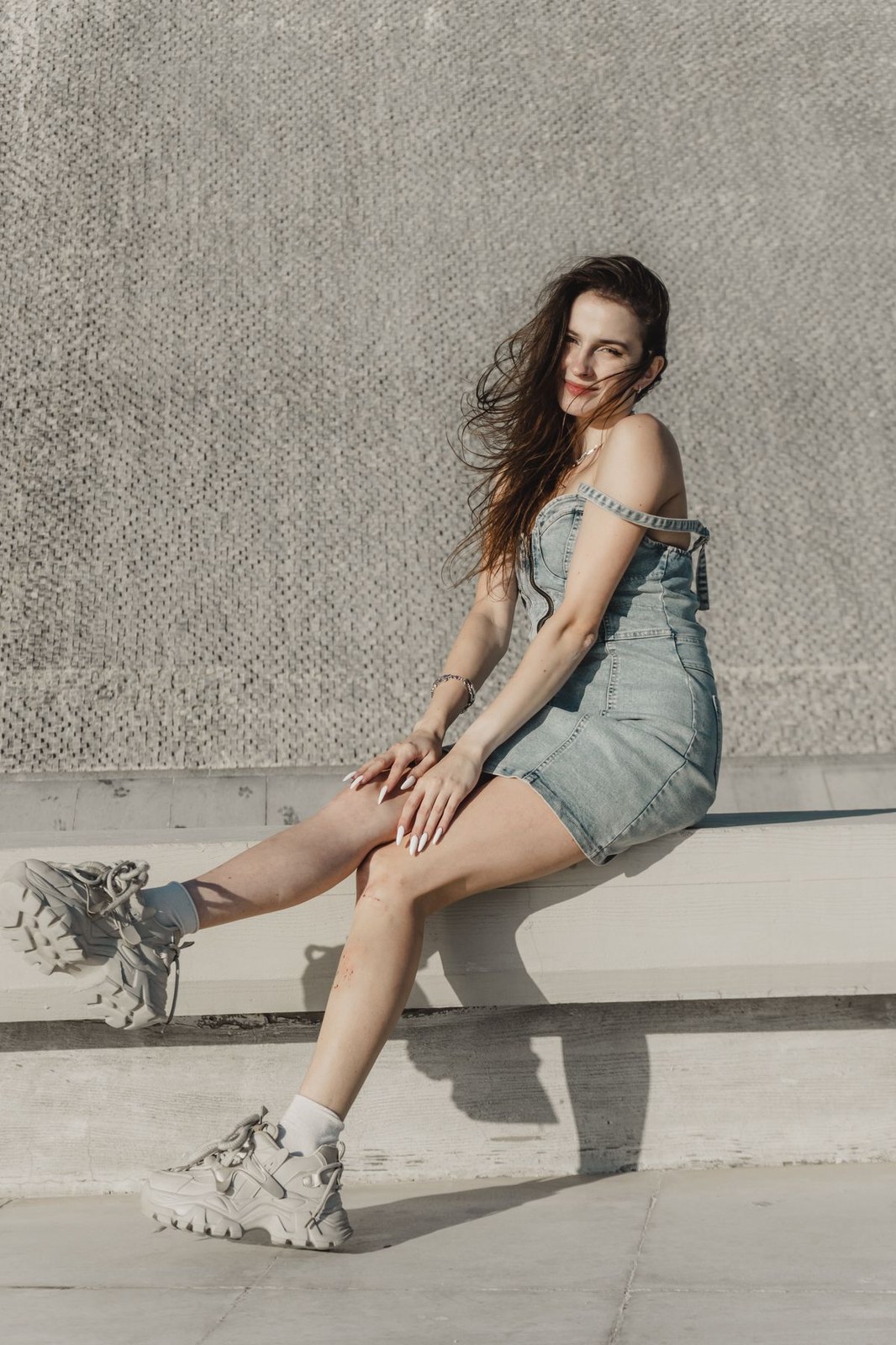 Plus size denim overall dress with chunky shoes styled for a casual street look