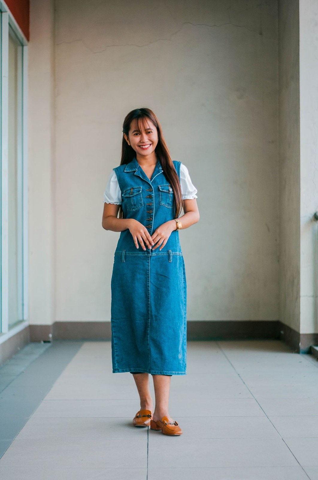 Plus size denim overall dress layered over a white tee for an everyday outfit