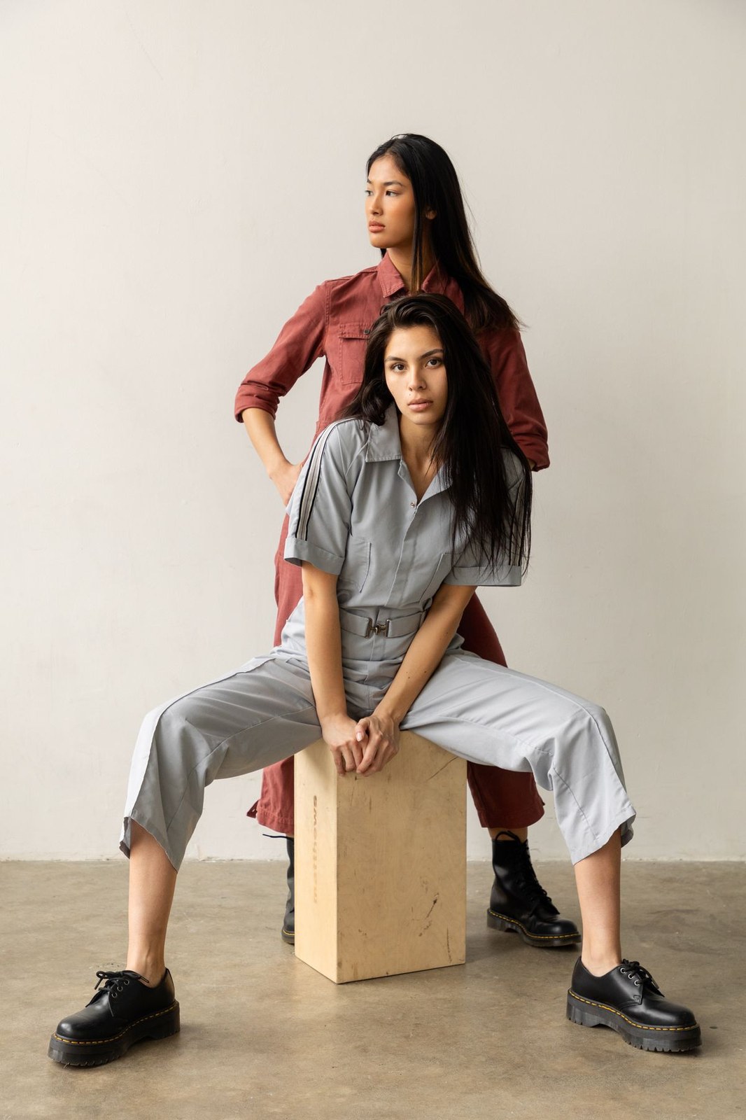 Two models in tailored one piece jumpsuits illustrating plus size overalls vs jumpsuits