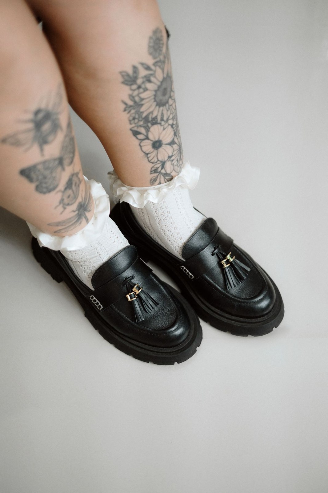 Plus size ruffle socks in white pointelle worn with chunky black loafers