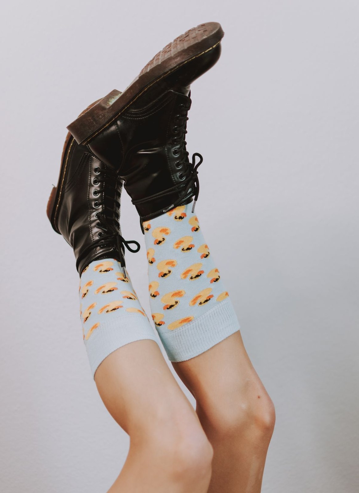 Plus size slouch socks layered with black lace up boots for a cosy fall look